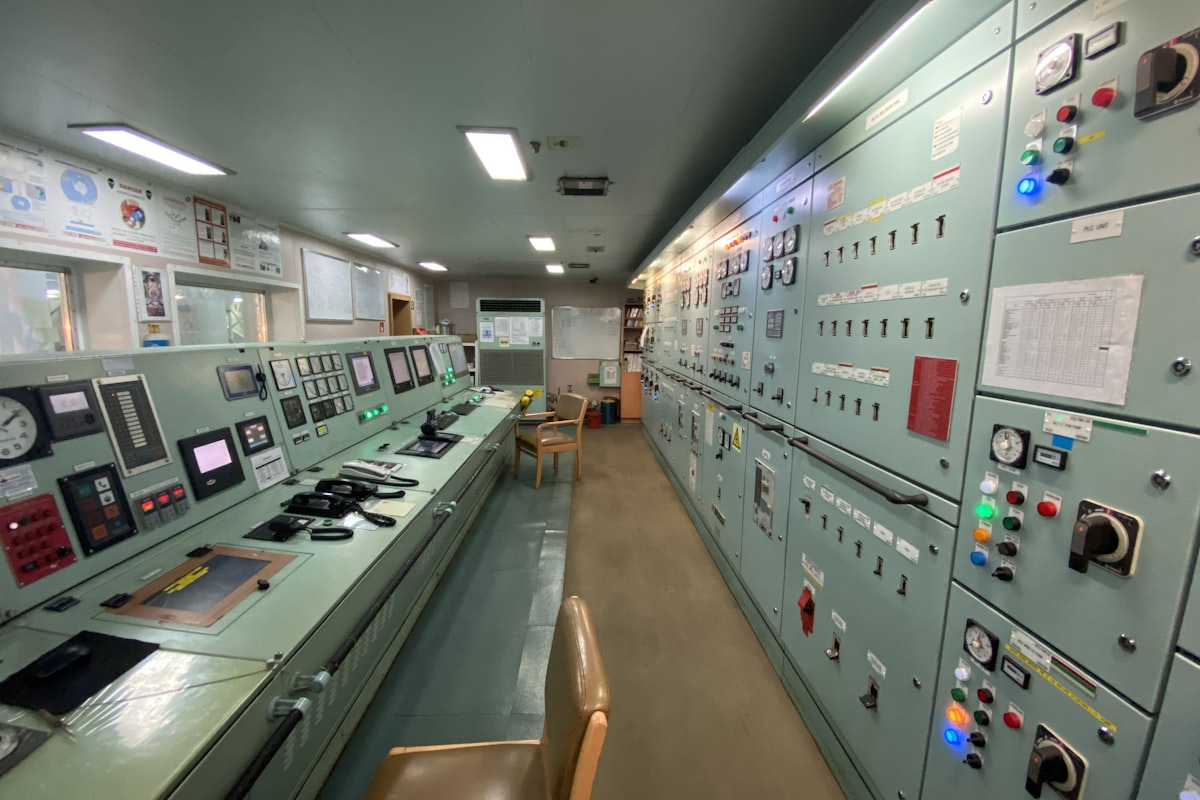 Industrial control room filled with electronic monitoring equipment — the kind of installation where A.Eberle PQ-Box power quality analyzers measure harmonics, THD, and voltage characteristics for EN 50160 and IEEE 519 compliance