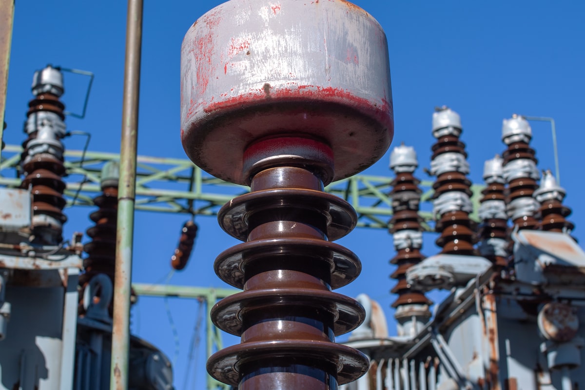 Porcelain-clad instrument transformers and insulators at an outdoor high-voltage substation - the metering and protection current and voltage transformers whose accuracy class and burden a Pakistani specification defines under IEC 61869