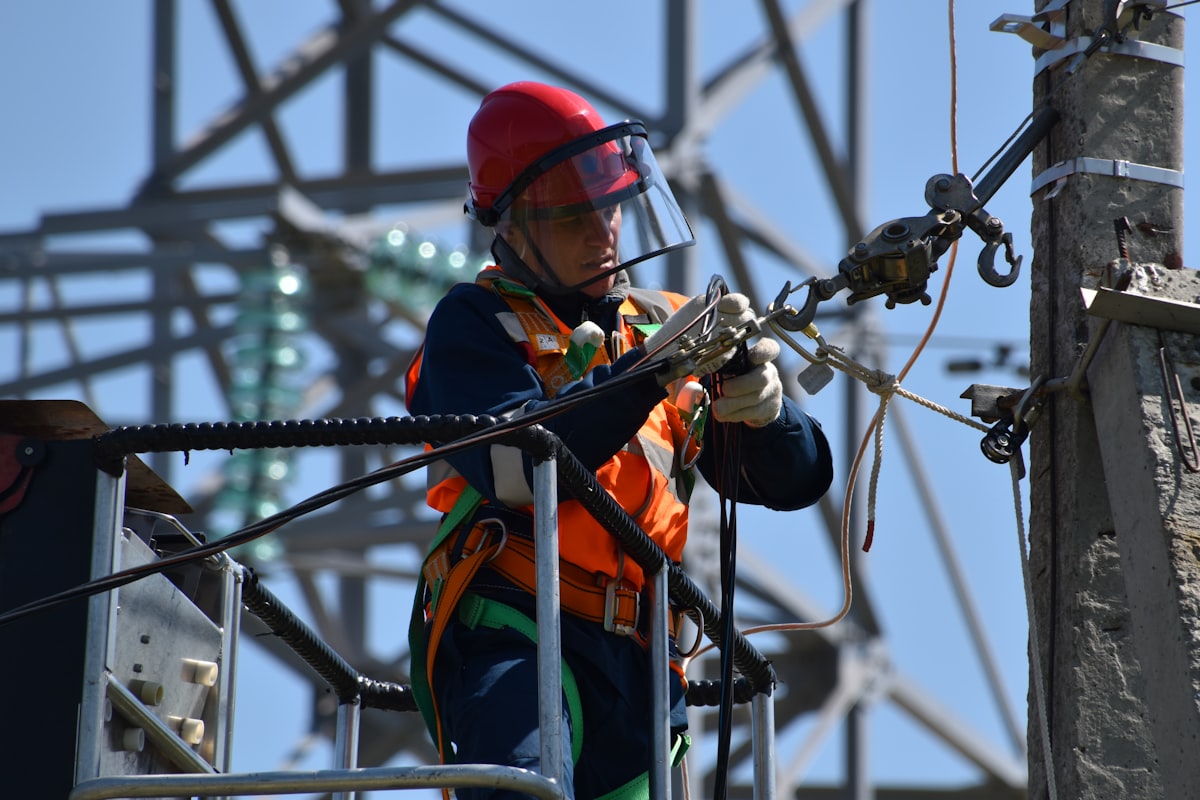 Electrical utility technician working on cable infrastructure — the kind of field crew that uses TDR, arc-reflection, and surge pinpointing equipment to locate underground cable faults on Pakistani DISCO 11 kV and 33 kV feeders