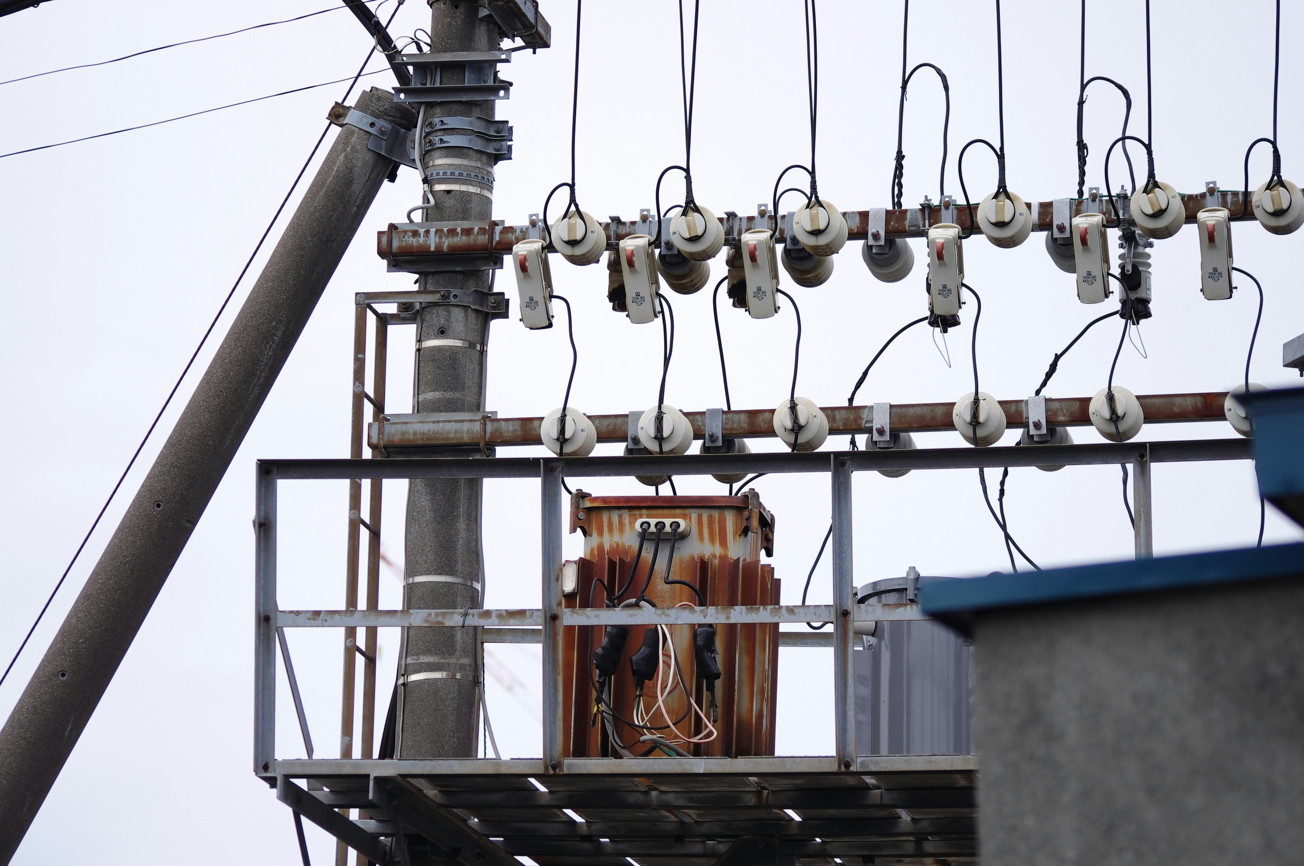 High voltage transformer at an outdoor substation at sunset